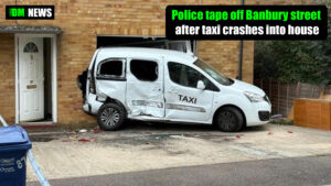 Police tape off Banbury street after taxi crashes into house